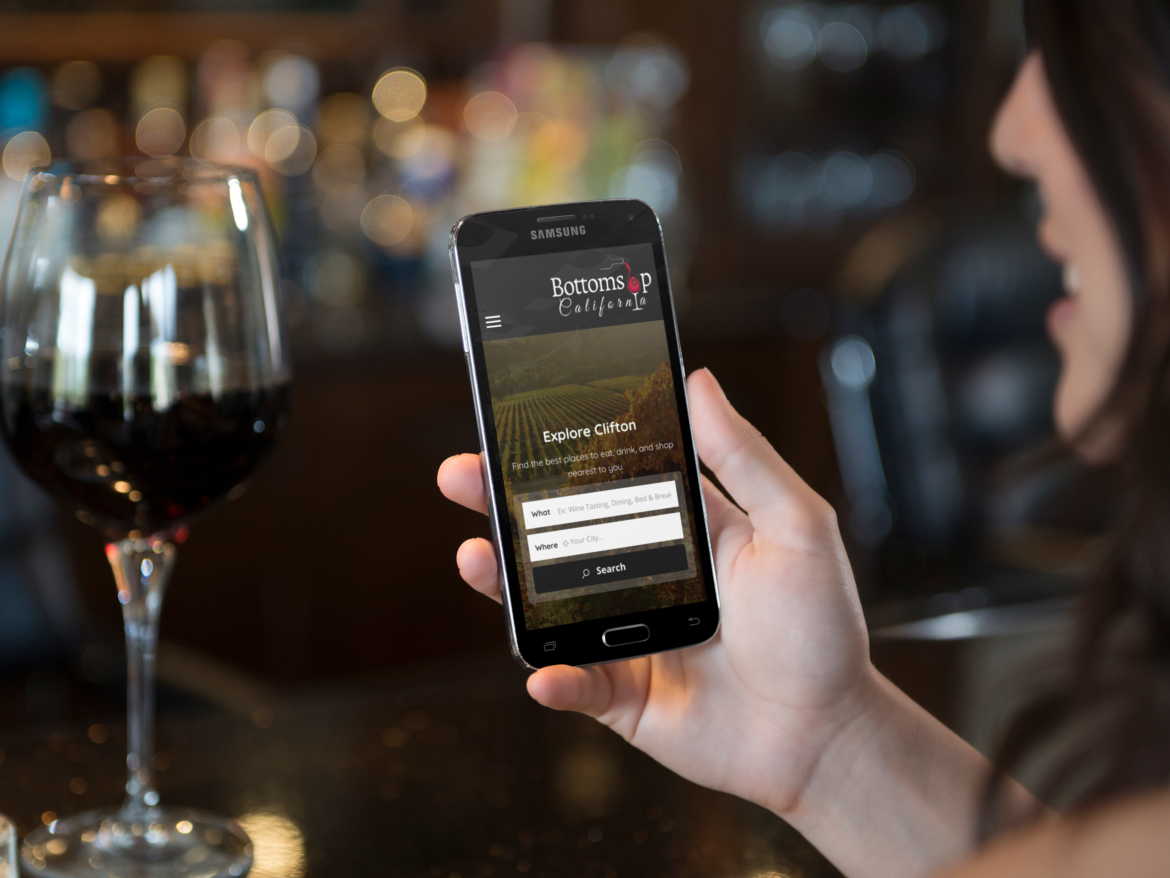 woman-holding-a-samsung-galaxy-while-drinking-wine
